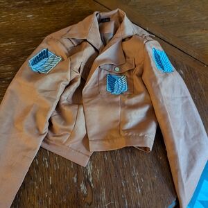 Tan Jacket with Blue Wing Patches